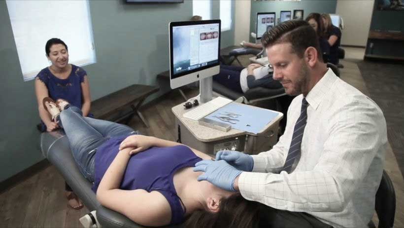 Dr. Rucker adjusting braces on a young teenage patient at his Temecula Orthodontists office.