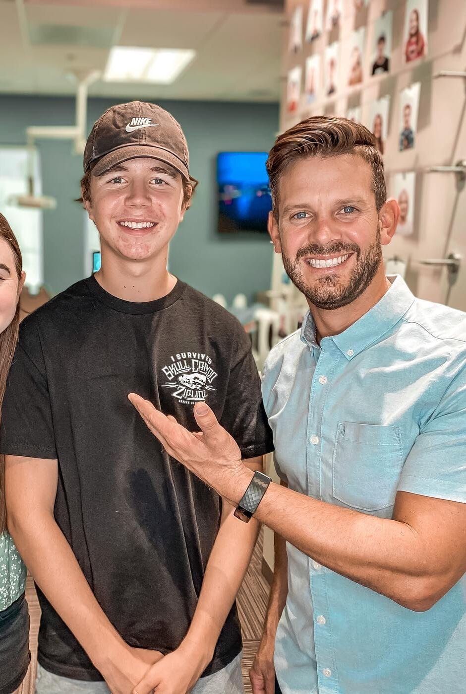 Dr. Rucker standing with a young man in his Temecula, Ca. Orthodontist office showing his completed treatment and fantastic smile.